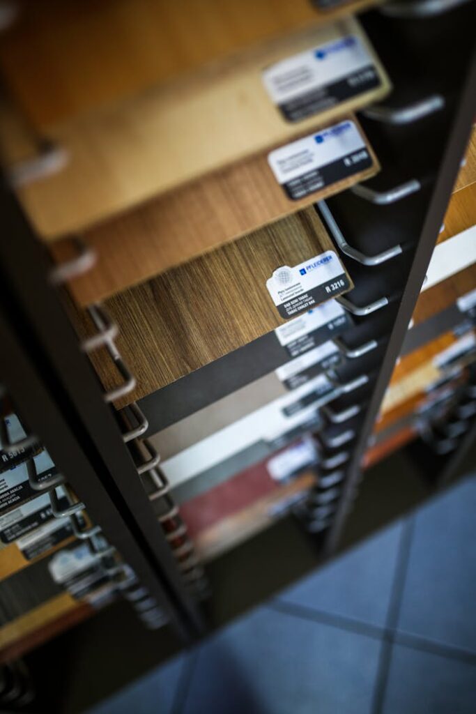 Close-up of various laminated wood veneer samples in a showroom display rack.